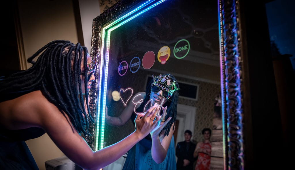 Women signing her photo on the touch screen of the Mirror Photo Booth Rental