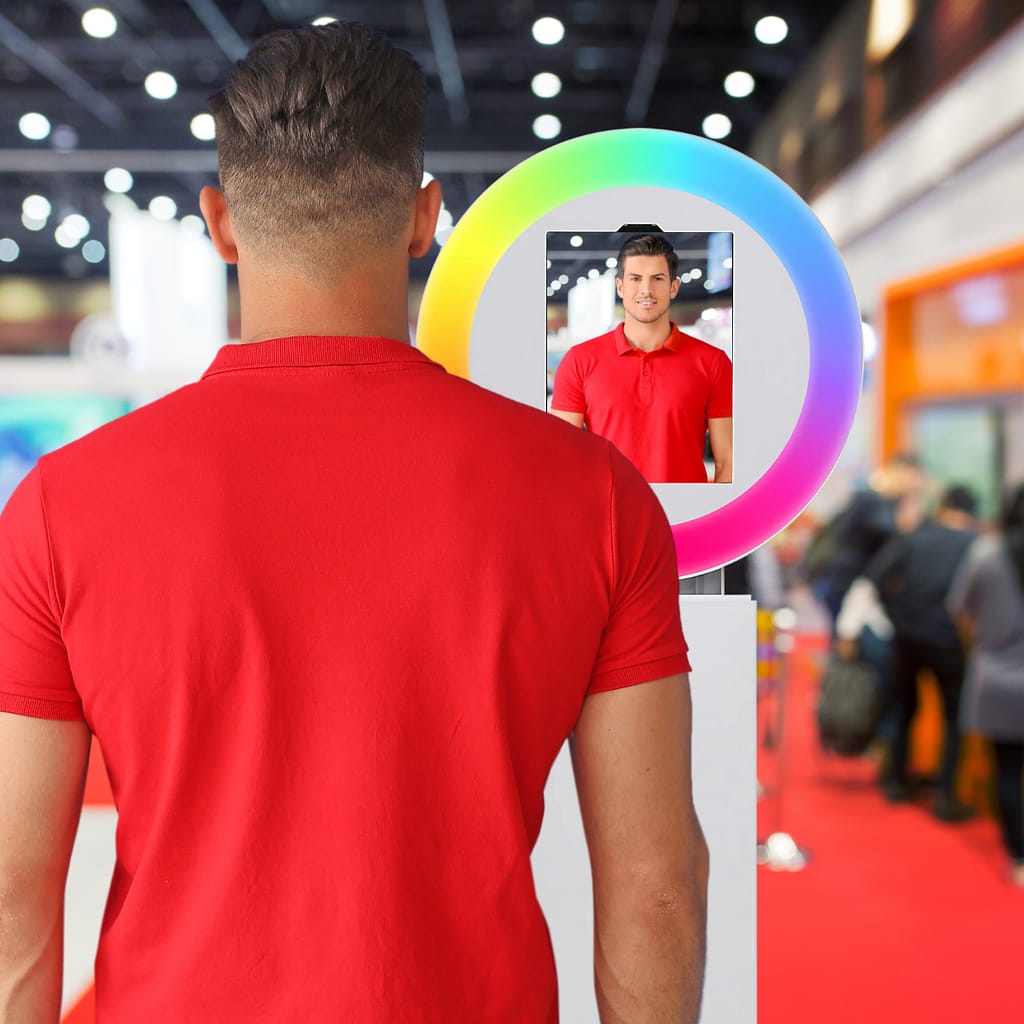 Mockup of a man in a red shirt taking a photo with an ai photo booth