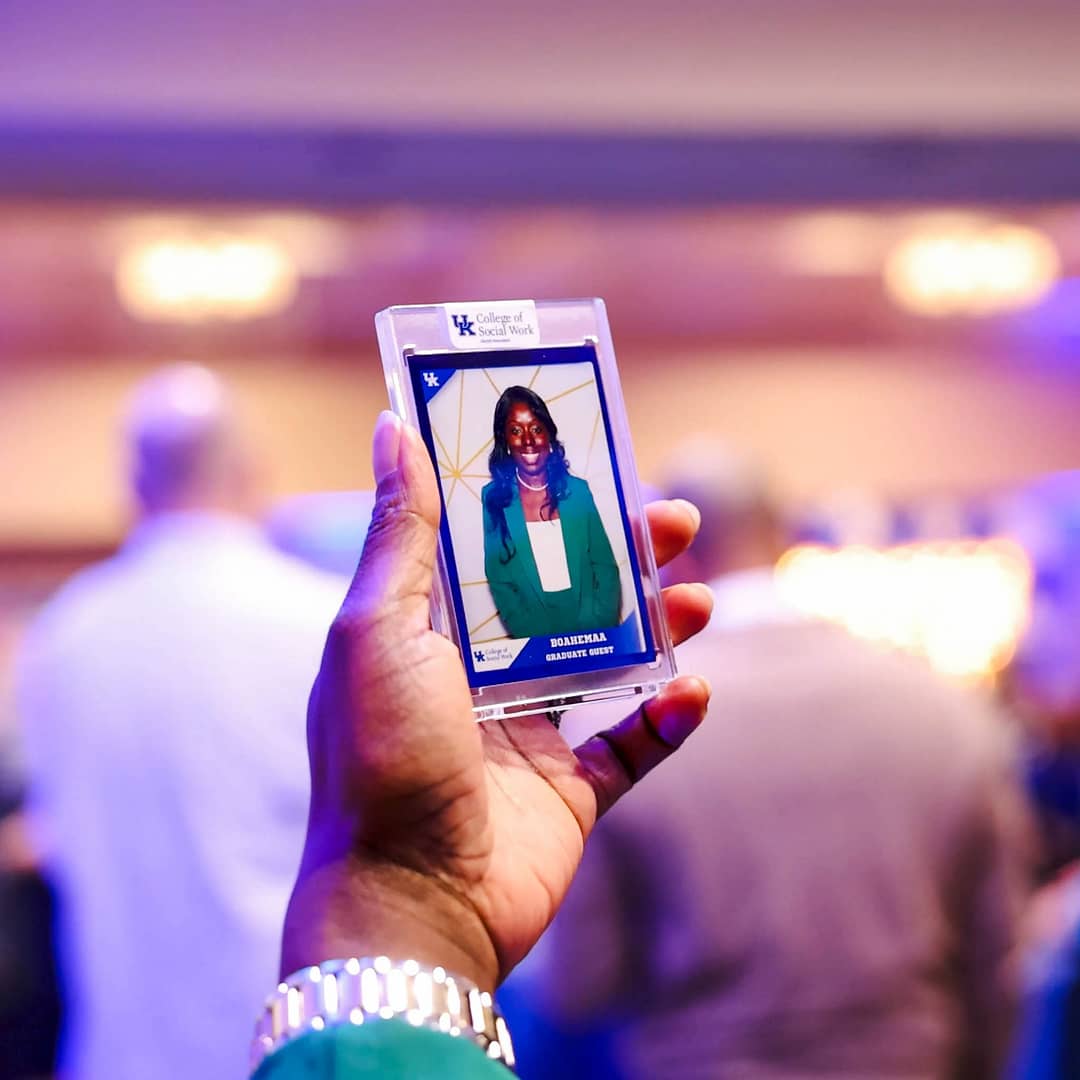 A woman looking at her custom trading card