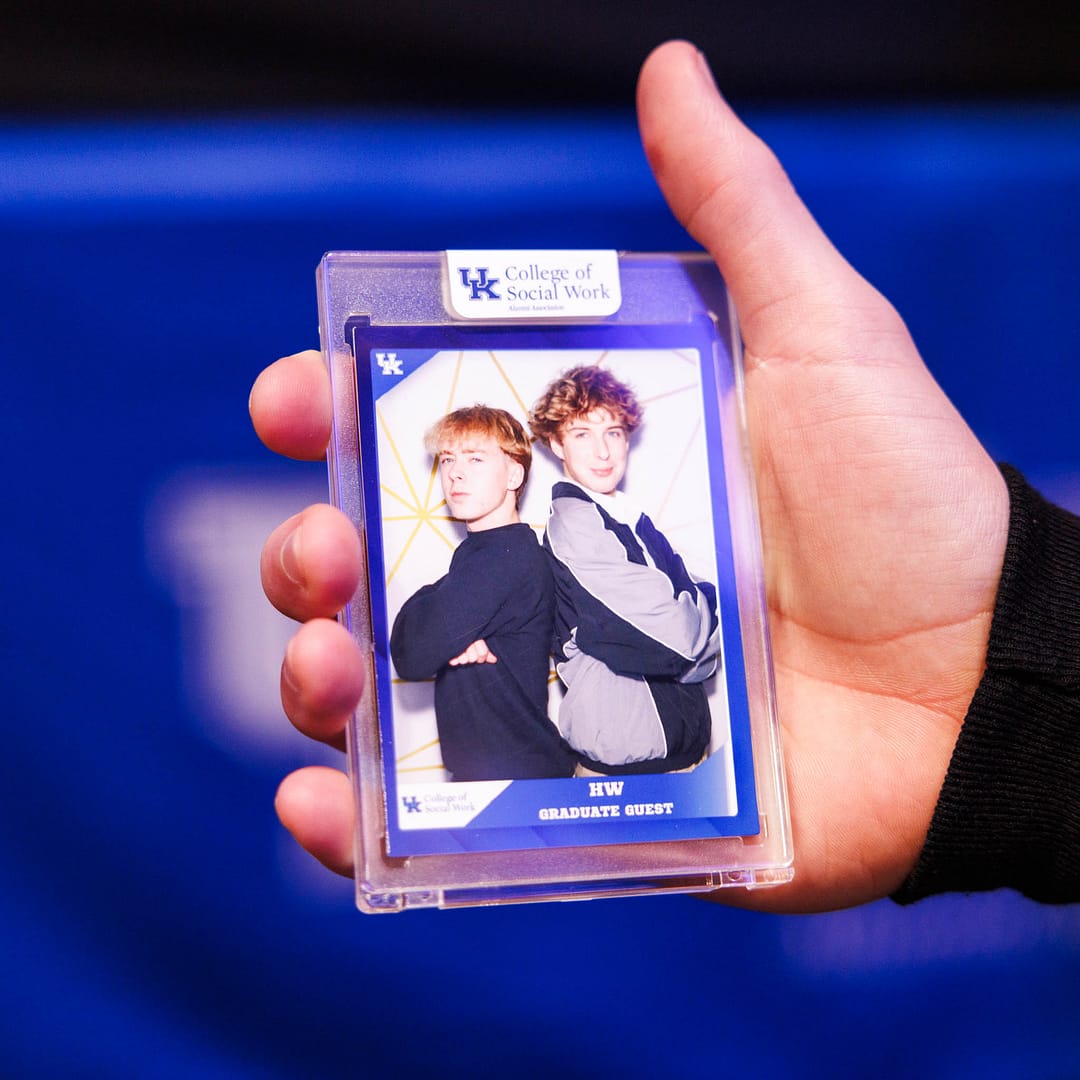 A guest holding their custom trading card in their hand