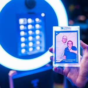 A guest at a college graduation holding their custom trading card