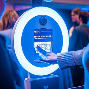 A guest typing their name into the trading card photo booth