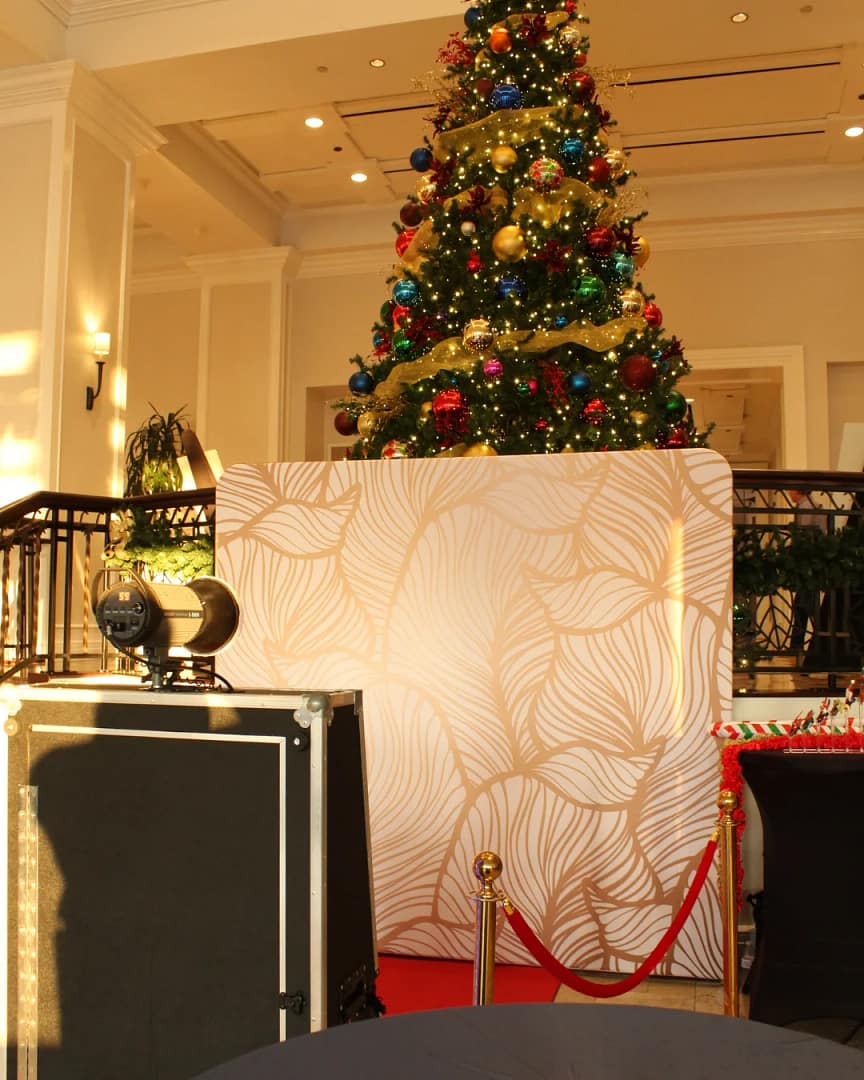 Mirror Photo Booth at a Christmas holiday party with a Christmas tree in background