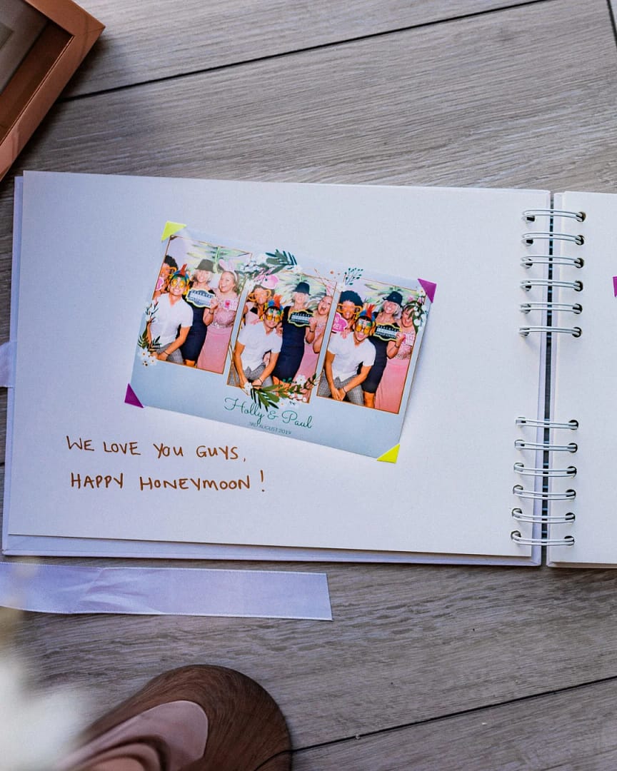 Photo placed in a wedding photo booth guestbook with a written message from a guest