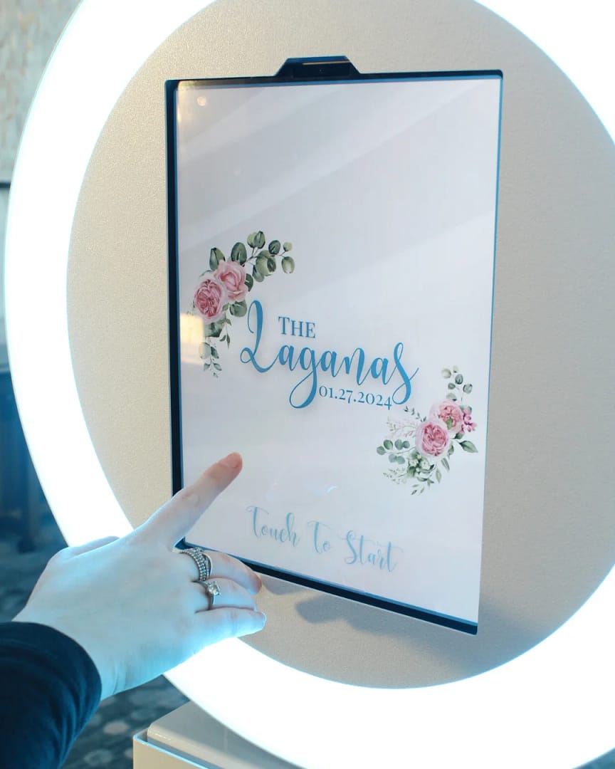 Guest touching the "touch to start" screen on a wedding photo booth rental